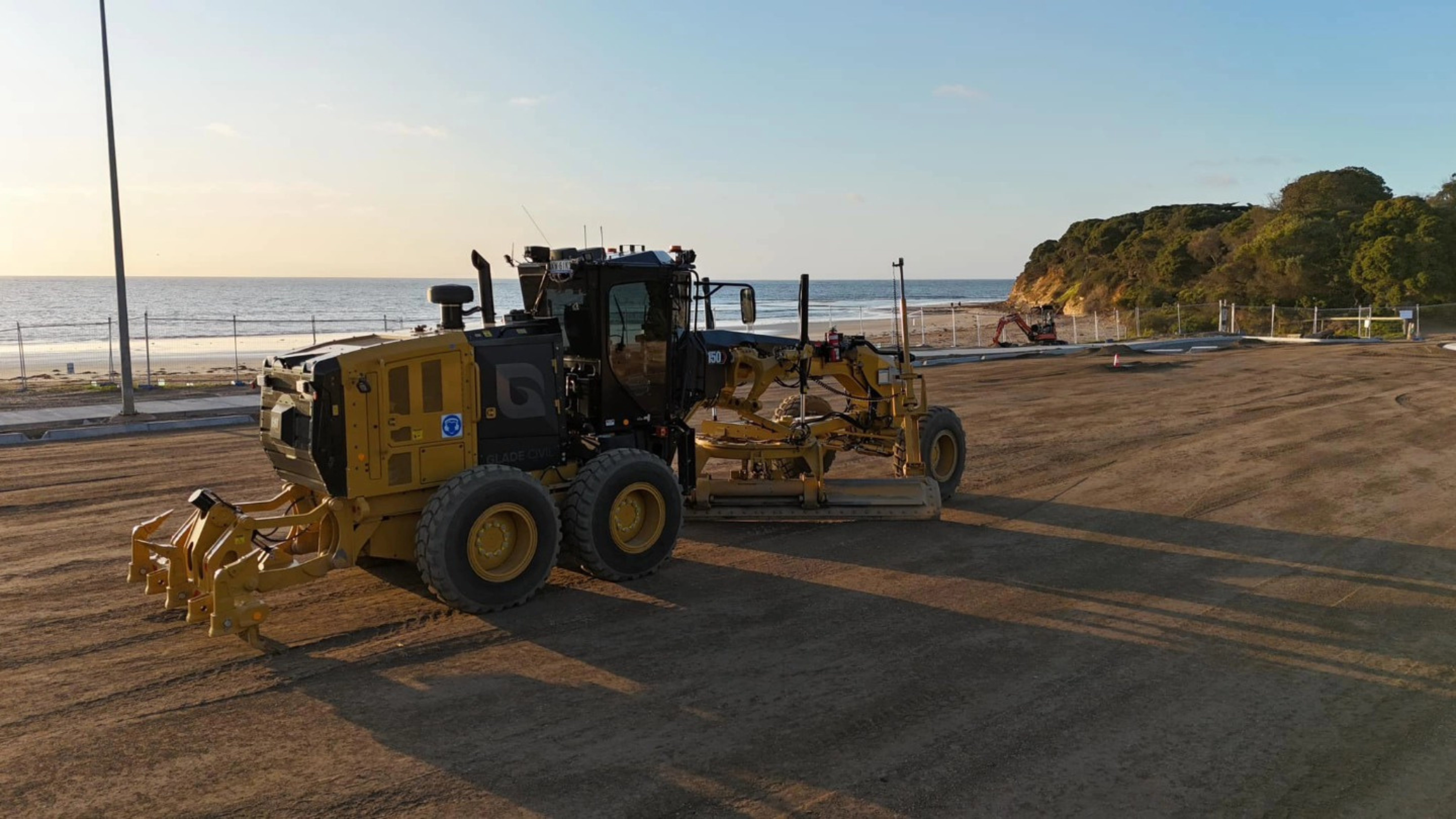 Glade Civil motor grader on a coastal job site